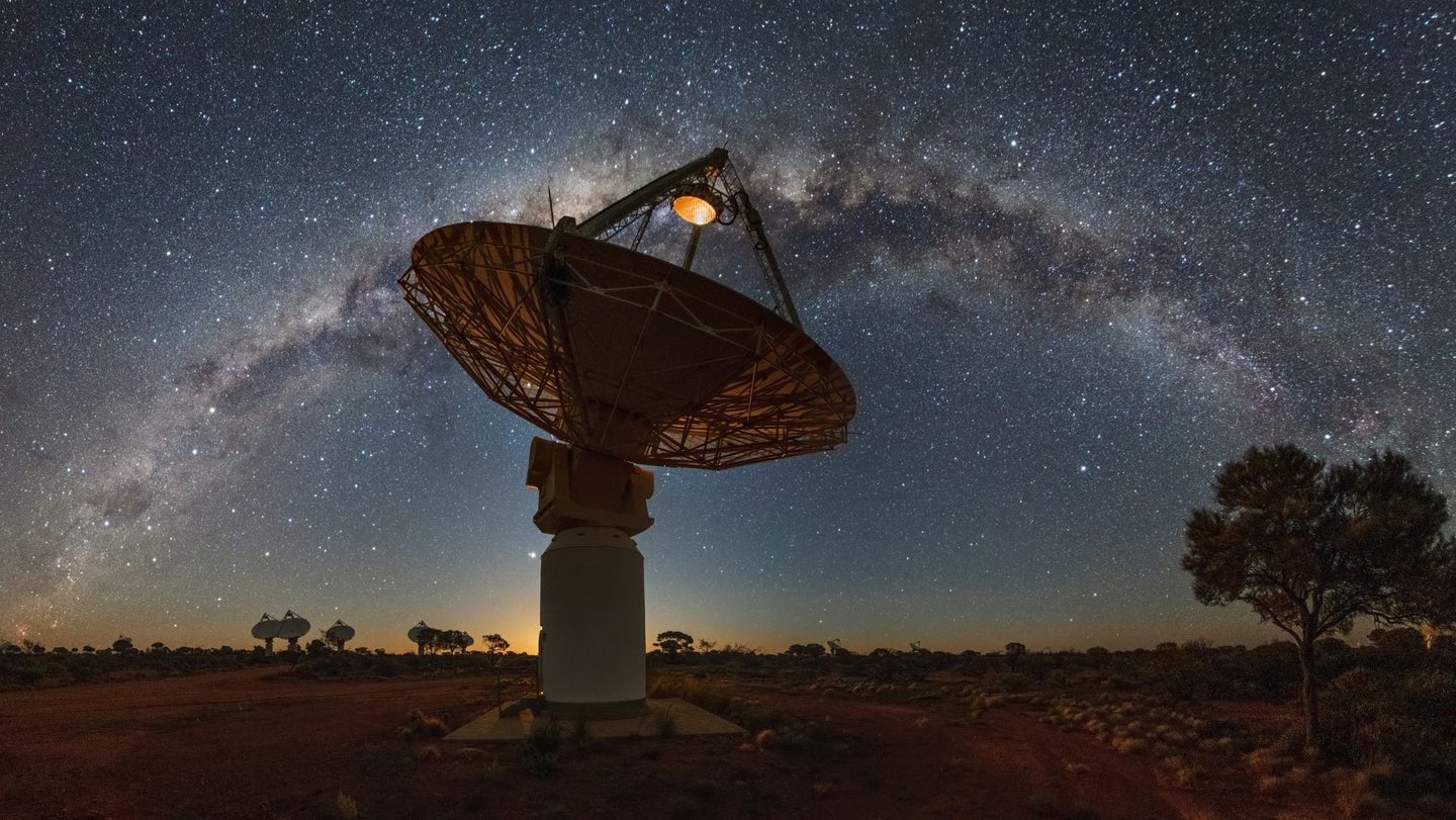 A radio telescope in Australia beneath the Milky Way.