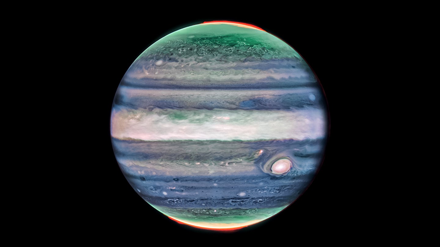 An image of Jupiter taken with the James Webb Space Telescope’s NIR Cam in July 2022. Researchers recently discovered a narrow jet stream traveling 320 miles per hour sitting over Jupiter’s equator above the main cloud decks. The numerous bright white "spots" and "streaks" are likely very high-altitude cloud tops of condensed convective storms. Auroras, appearing in red in this image, extend to higher altitudes above both the northern and southern poles of the planet.